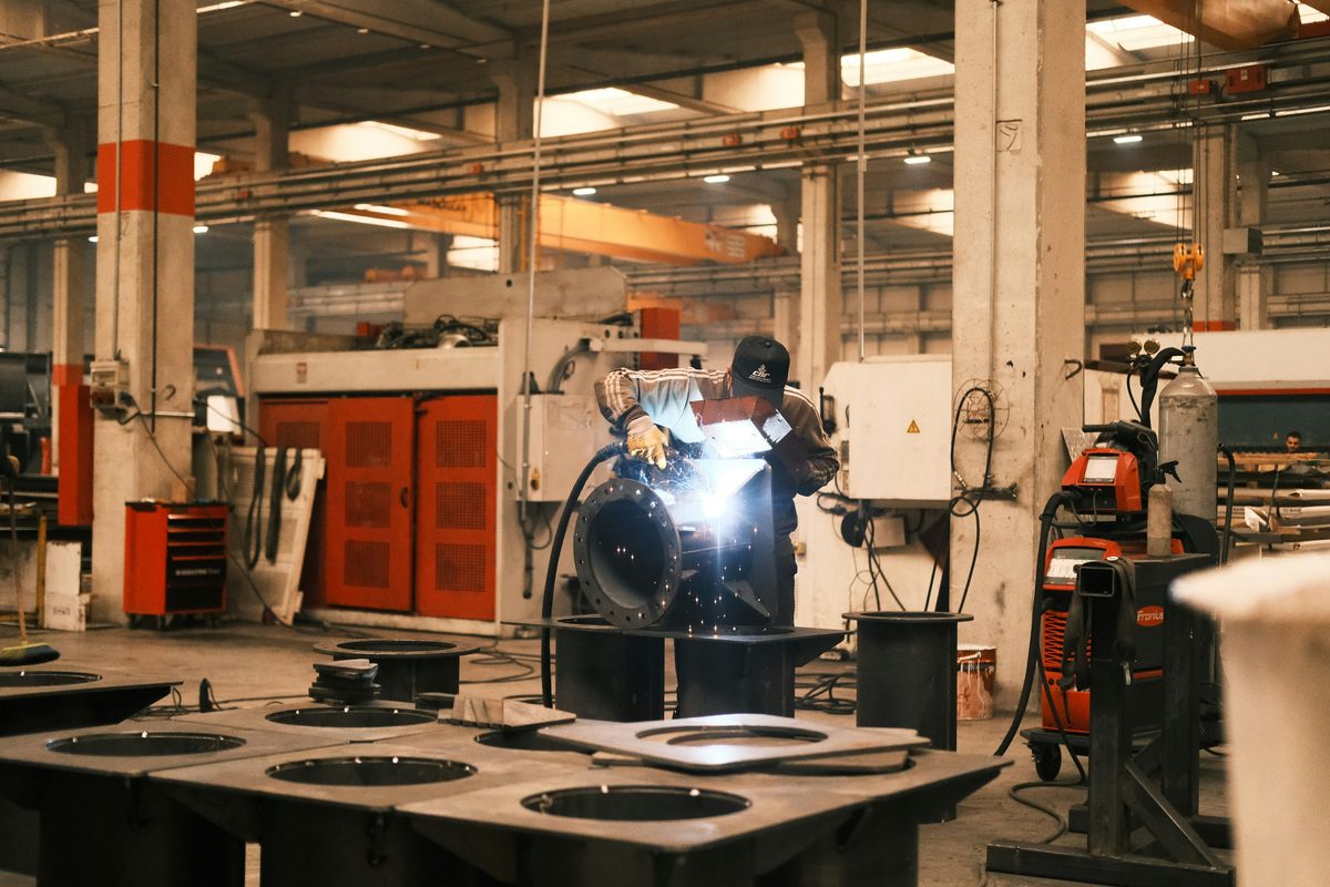 Welder working on metal in a machine shop